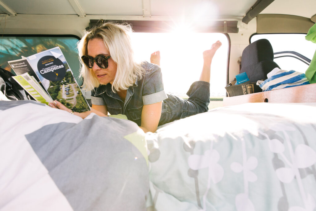 Women reading book in campervan